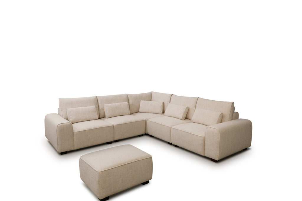 Beige sectional sofa with ottoman on a white background